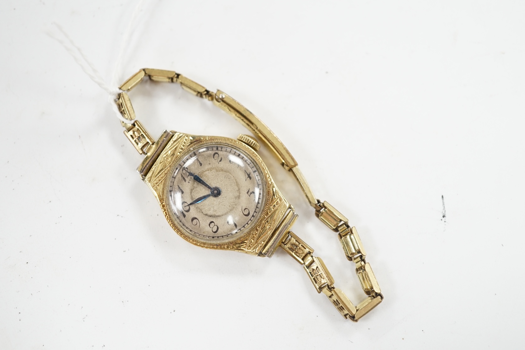 A lady's 14k manual wind wrist watch, with Arabic dial and engraved case, on a gold plated bracelet. Condition - poor